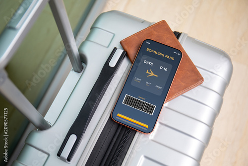 Mobile phone with digital boarding pass at airport and luggage
