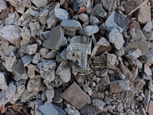 Photography Close-up of demolished building materials showing broken concrete, bricks, and debris with rough textures