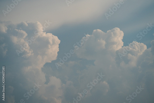 White cumulus clouds in a blue summer sky