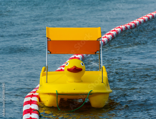 cute yellow toy boat on the sea