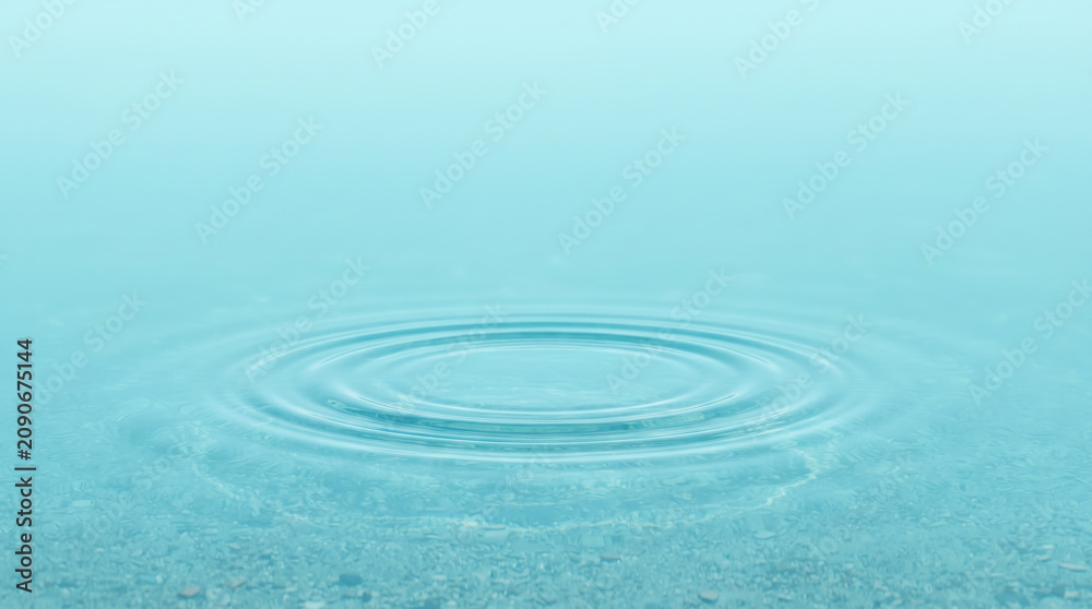 Fototapeta premium Circular ripple wave on the surface of calm blue water