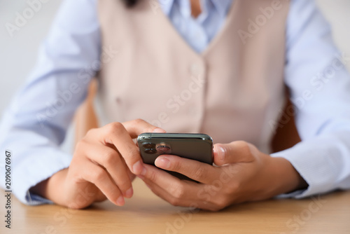 Young businesswoman using m...