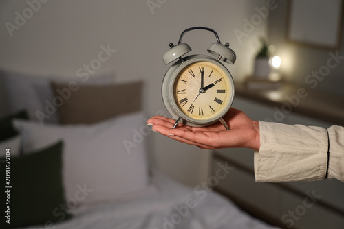 Female hand holding alarm c...