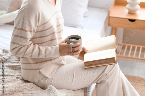 Young woman with cup of hot...