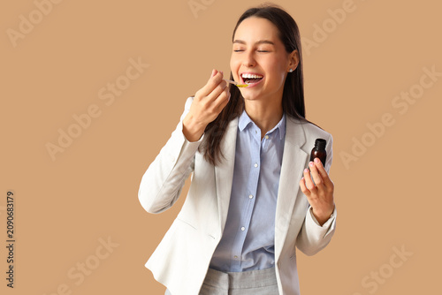 Young woman with syrup for ...