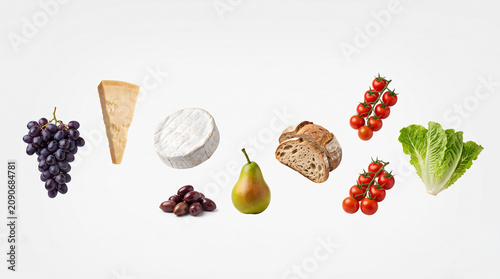 Minimal Elegant Levitation of Grapes Hard Cheese Camembert Olives Pear Rustic Bread Cherry Tomatoes and Lettuce
