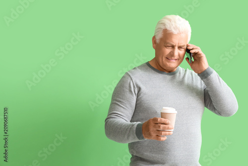 Senior man with cup of coff...