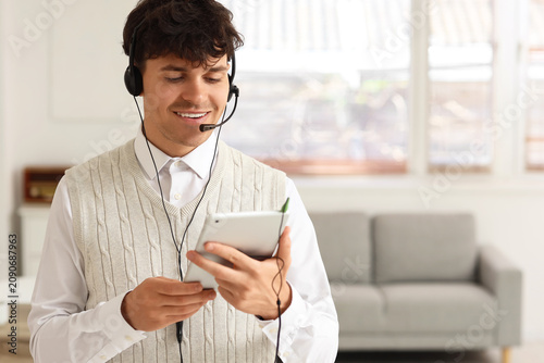 Male technical support agent with tablet computer in office