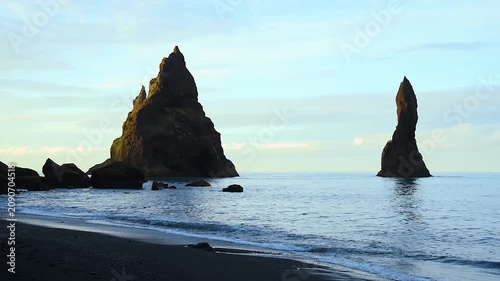 Magical majestic dramatic scenic landscape with Reynisdrangar Sea Cliffs and stones called Troll Fingers under the Reynisfjall Mountain near Vik, Iceland.