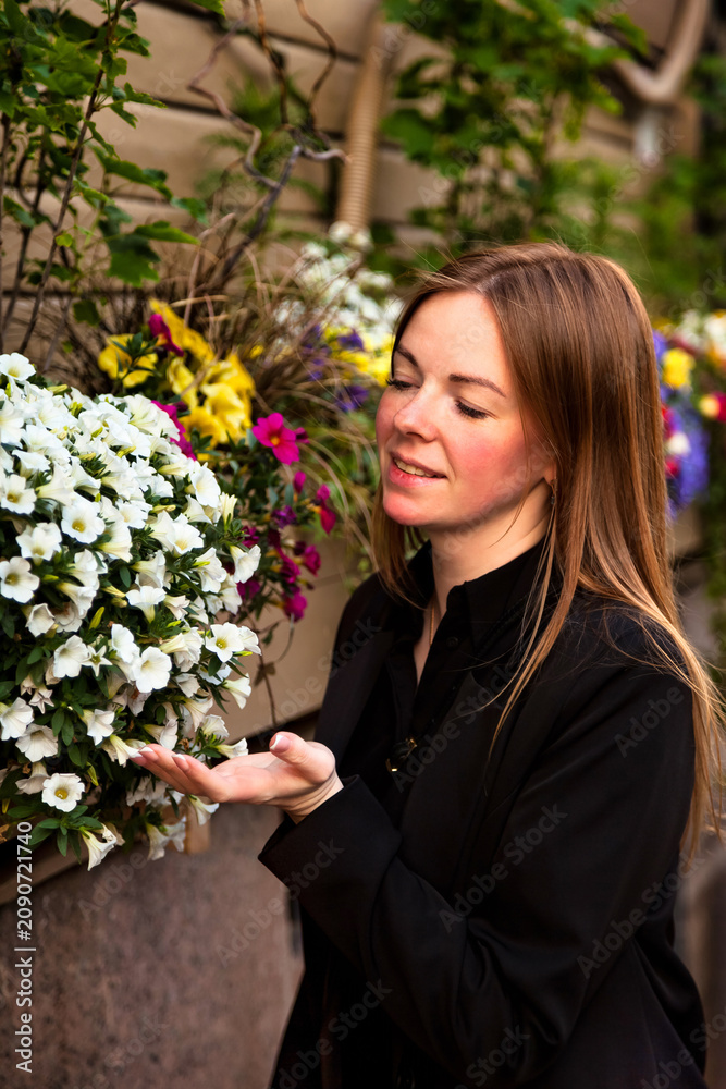 Fototapeta premium Woman Enjoying Vibrant Flowers in a Sunny Outdoor Setting While Embracing Nature's Beauty
