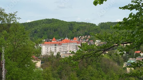 View Karlovy Vary in Czech Republic with clear sights of a historical building surrounded by nature. The show highlights the beauty of the area in springtime.