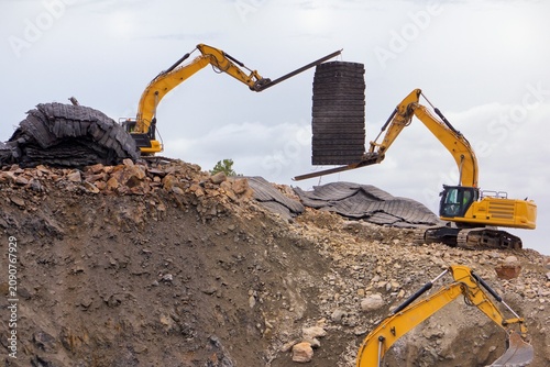 Excavator with Blasting mat, heavy machine construction site