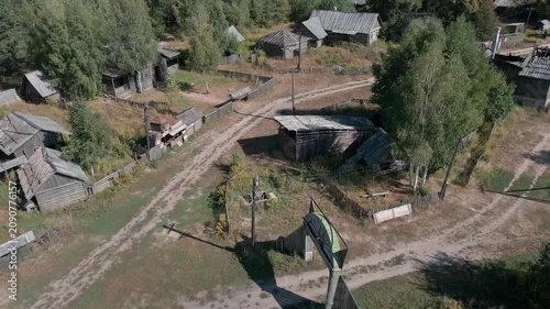 Aerial Drone Flight Over Historic Wooden Village by Lake Surrounded by Forest