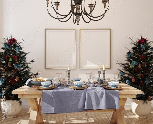 Elegant holiday dining room with decorated evergreen trees, framed wall decor, chandelier, wooden table, blue tableware, candles, glassware, and festive interior styling in bright daylight
