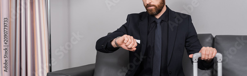 Fotografía Elegant young man in a dapper suit waits patiently in a stylish hotel lobby
