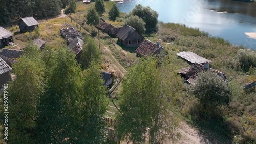 Aerial Drone Flight Over Historic Wooden Village by Lake Surrounded by Forest