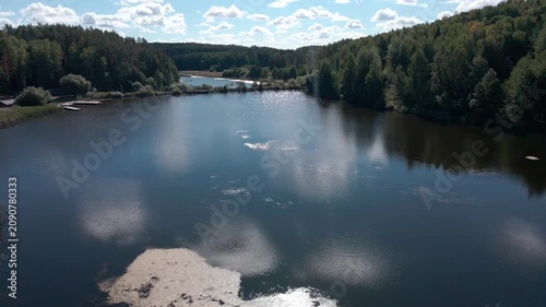 Aerial Drone Flight Over Historic Wooden Village by Lake Surrounded by Forest