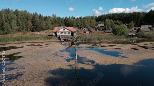 Aerial Drone Flight Over Historic Wooden Village by Lake Surrounded by Forest