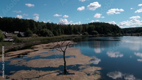 Aerial Drone Flight Over Historic Wooden Village by Lake Surrounded by Forest