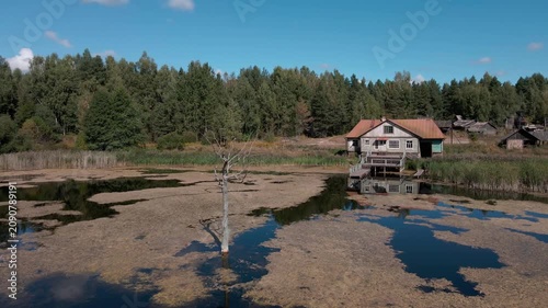 Aerial Drone Flight Over Historic Wooden Village by Lake Surrounded by Forest