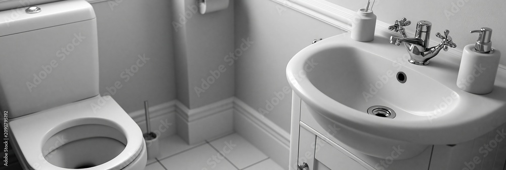 Fototapeta premium Clean Bathroom Interior with White Toilet and Sink, Modern Design, Sanitary Fixtures