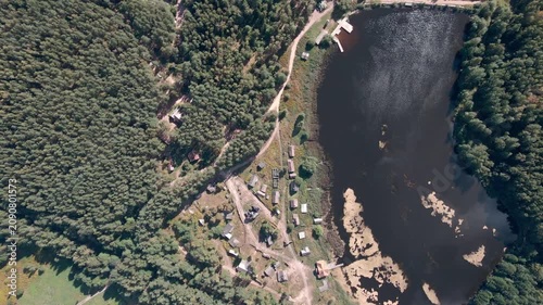 Aerial Drone Flight Over Historic Wooden Village by Lake Surrounded by Forest