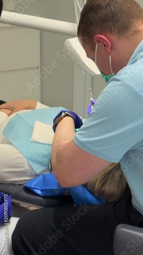 Complete dental filling procedure with patient dentist microscope anesthesia rubber dam and modern restorative treatment set. professional dental care.
