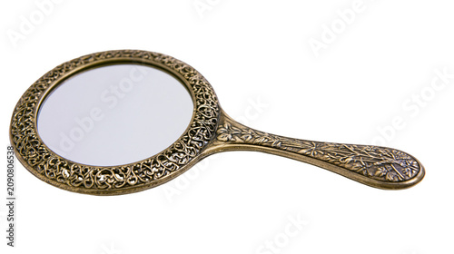 Foto Antique ornate hand mirror with floral engravings