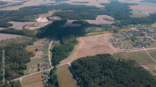 Aerial Drone Flight Over Historic Wooden Village by Lake Surrounded by Forest