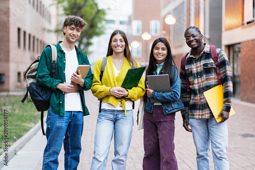 Positive students standing on university campus, ready to start academic course lectures