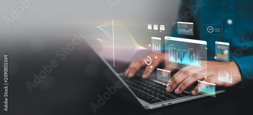 Obraz na płótnie Business professional analyzing financial data dashboards on laptop with virtual