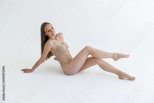 Konstfotografi Fashionable photo of young woman wearing beige lingerie in studio