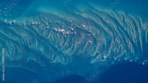 Aerial photo of submerged dunes shaped by currents in the clear blue waters off the coast of Eleuthera in the Bahamas.