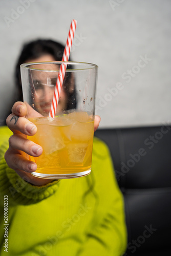 Person holding a refreshing iced glass drink