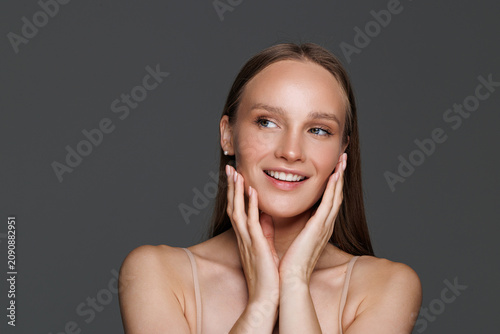 Quadro su tela Beauty, skincare and smile with face of woman in studio on gray background for aesthetic or cosmetics