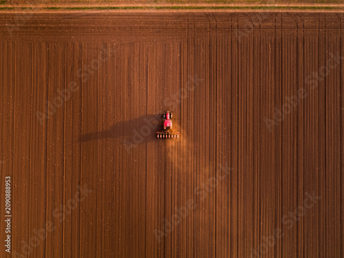 Tractor cultivating farmland drone aerial view farming
