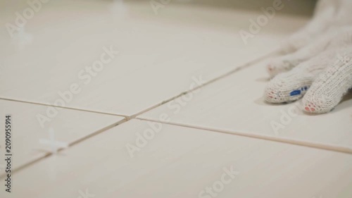 Professional Tile Setter Laying Ceramic Tiles During Remodeling
