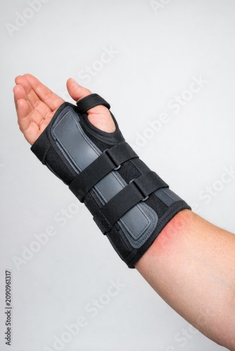 A close-up of a hand with a splint on it, used for medical purpose or to protect an injured limb