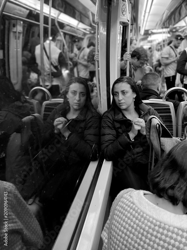 Photos Woman observing her reflection on subway ride