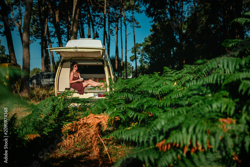 Konstfotografi Man Relaxing in Open Vintage Campervan in Pine Forest – Van Life Lifestyle