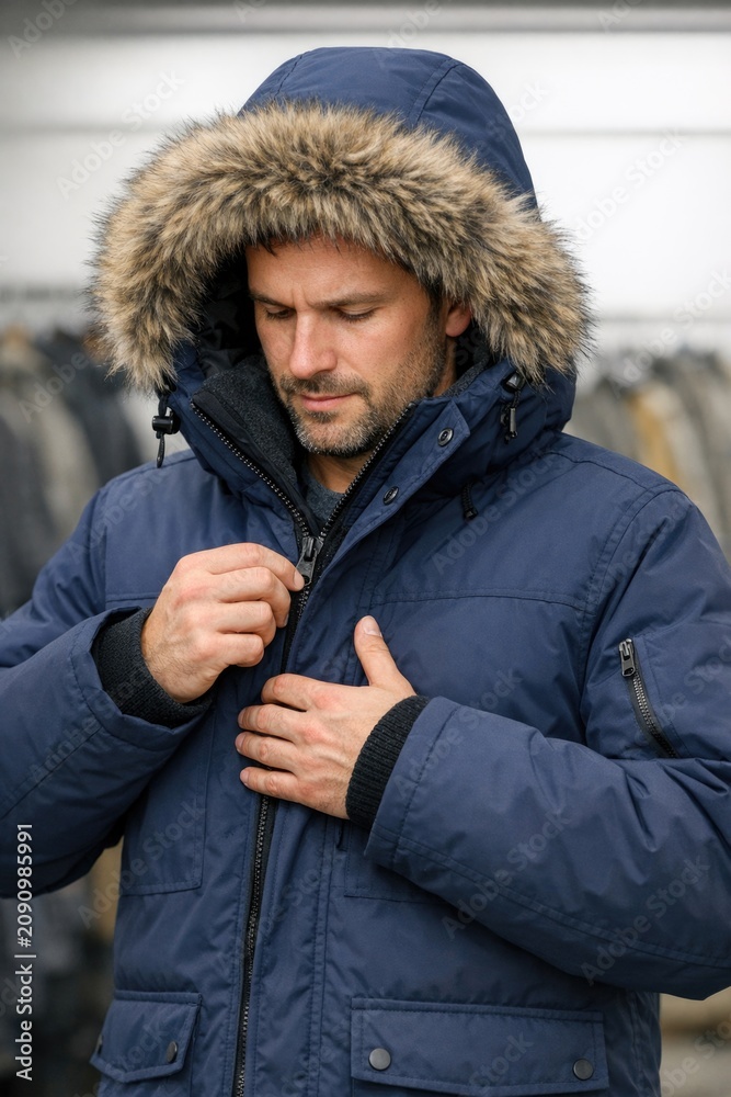 Fototapeta premium A person fixing his blue jacket, suitable for corporate or formal events
