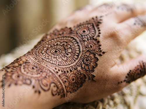 Extreme macro close-up of intricate mehndi henna pattern on hand skin showing detailed mandala design, Indian bridal tradition concept