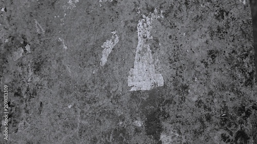 Bild auf Leinwand Black and white aged cement background with patchy stains, worn plaster traces, rough surface grain, and distressed urban texture