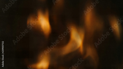 Quadro su tela Abstract fire flames close up, warm orange and yellow blaze background, smoky da