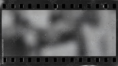 Konstfotografi Vintage film strip frame with sprocket holes, blurry grayscale abstract backgrou