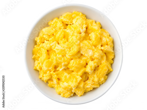 Freshly cooked scrambled eggs served in a white ceramic bowl isolated on a clean white background