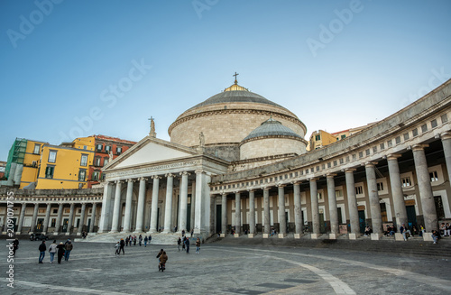 Naples, italy. December 27, 2024. Tourists visiting piazza del plebiscito, a large public square in naples, italy, with the neoclassical church san francesco di paola