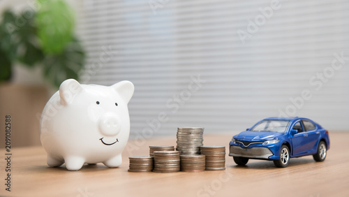Canvas Print Piggy bank, toy car, and stacked coins on a wooden table with copy space, symbolizing car savings, vehicle financing, auto loans, personal budgeting, financial planning, and long-term wealth growth