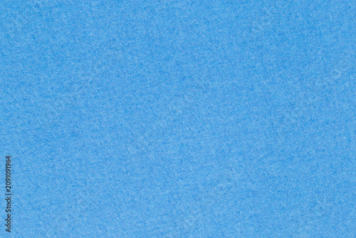 sky blue backdrop: close up of dense matte craft paper surface