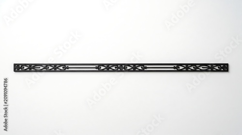 Decorative Black Metal Ruler with Intricate Geometric Pattern on White Background